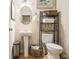 Cozy bathroom features a pedestal sink, toilet, decorative shelves, and stylish decor at 2294 Spicy Pine Ln, Lawrenceville, GA 30044