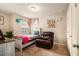 A bright bedroom is furnished with a small bed and comfortable armchair at 2294 Spicy Pine Ln, Lawrenceville, GA 30044