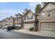 Street view of well-maintained townhomes with two-car garages, neutral siding, and tidy landscaping at 2294 Spicy Pine Ln, Lawrenceville, GA 30044