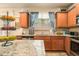A well-lit kitchen with granite countertops, stainless steel appliances, and a view from the kitchen island at 2294 Spicy Pine Ln, Lawrenceville, GA 30044