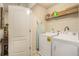 Functional laundry room featuring a washer, dryer, and ample storage space at 2294 Spicy Pine Ln, Lawrenceville, GA 30044