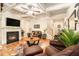 Cozy living room with fireplace, hardwood floors, coffered ceilings, and ample seating at 2294 Spicy Pine Ln, Lawrenceville, GA 30044