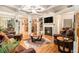 Spacious living room featuring coffered ceilings, hardwood floors, fireplace, and comfortable leather furniture at 2294 Spicy Pine Ln, Lawrenceville, GA 30044