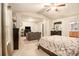 Bright main bedroom with seating area, ceiling fan, and private bathroom access at 2294 Spicy Pine Ln, Lawrenceville, GA 30044