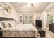 Well-lit main bedroom with floral bedding, a seating area, and a bright, airy atmosphere at 2294 Spicy Pine Ln, Lawrenceville, GA 30044