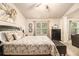 Main bedroom suite features a bed, seating area, stylish decor, and natural light at 2294 Spicy Pine Ln, Lawrenceville, GA 30044