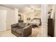 Spacious main bedroom with seating area, fan, columns, and a view of the en suite bathroom at 2294 Spicy Pine Ln, Lawrenceville, GA 30044