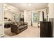 Spacious main bedroom featuring a cozy seating area, natural light, and neutral color palette at 2294 Spicy Pine Ln, Lawrenceville, GA 30044