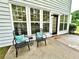 Inviting back patio with seating, exterior door, and large windows offering natural light into the home at 608 Chickory Ct, Woodstock, GA 30188