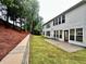 Spacious backyard with newly installed sod, retaining wall, and access to the home through the back patio at 608 Chickory Ct, Woodstock, GA 30188
