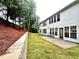 Spacious backyard with newly installed sod, retaining wall, and access to the home through the back patio at 608 Chickory Ct, Woodstock, GA 30188