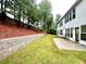 Spacious backyard with newly installed sod, retaining wall, and access to the home through the back patio at 608 Chickory Ct, Woodstock, GA 30188