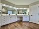 Bright bathroom vanity with dual sinks and ample counter space with wood look vinyl flooring at 608 Chickory Ct, Woodstock, GA 30188