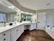 A luxurious bathroom featuring a double vanity, large mirror, and elegant finishes at 608 Chickory Ct, Woodstock, GA 30188