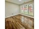 Bright bedroom with wood look vinyl flooring and three large windows for natural light at 608 Chickory Ct, Woodstock, GA 30188
