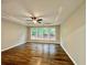Bedroom featuring tray ceiling, ceiling fan and plenty of natural light with wood look vinyl flooring at 608 Chickory Ct, Woodstock, GA 30188