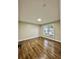 Cozy bedroom with gleaming hardwood floors and a bright, sunlit ambiance at 608 Chickory Ct, Woodstock, GA 30188