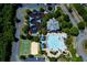Aerial view of a large pool with a slide and many seats surrounded by lush green trees at 608 Chickory Ct, Woodstock, GA 30188