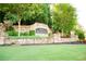 Stone entrance sign for Woodlands neighborhood surrounded by greenery and landscaping at 608 Chickory Ct, Woodstock, GA 30188