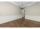 Dining room features decorative molding and a contemporary chandelier at 608 Chickory Ct, Woodstock, GA 30188