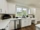 Modern kitchen featuring white cabinets, stainless steel appliances, and a bright window over the sink at 608 Chickory Ct, Woodstock, GA 30188