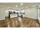 Open-concept kitchen and living area with hardwood floors and recessed lighting at 608 Chickory Ct, Woodstock, GA 30188