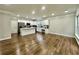 Large kitchen with white cabinetry, stainless steel appliances, island, and luxury vinyl plank flooring throughout at 608 Chickory Ct, Woodstock, GA 30188