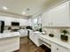 Bright kitchen with white cabinets, stainless steel appliances, luxury vinyl plank flooring, and a built-in desk area at 608 Chickory Ct, Woodstock, GA 30188