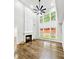 Spacious living room with soaring ceilings, statement fireplace, and expansive windows with backyard views at 608 Chickory Ct, Woodstock, GA 30188