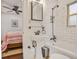 Compact bathroom adjacent to the bedroom features a tub/shower combo and pedestal sink at 728 Antone Nw St, Atlanta, GA 30318
