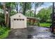 Detached garage with adjacent covered parking, landscaping, and rear yard access at 728 Antone Nw St, Atlanta, GA 30318
