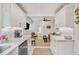 Stylish kitchen with white cabinetry, stainless appliances, and an open flow to the living area at 728 Antone Nw St, Atlanta, GA 30318