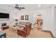 Spacious living room featuring a cozy fireplace, seating, and dining area access at 728 Antone Nw St, Atlanta, GA 30318
