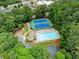 A community pool, tennis courts and playground are surrounded by lush greenery creating a resort-like environment at 1340 Gran Forest Dr, Cumming, GA 30041