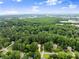 Aerial view of the community and surrounding green landscape shows proximity to commercial areas at 1340 Gran Forest Dr, Cumming, GA 30041