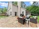 Stone patio with outdoor seating and grill in the backyard of home at 1340 Gran Forest Dr, Cumming, GA 30041