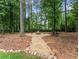 Cozy backyard fire pit area with gravel surround and natural stone accents, perfect for outdoor relaxation at 1340 Gran Forest Dr, Cumming, GA 30041