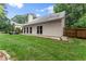 View of house back with stone patio, lawn and fenced yard at 1340 Gran Forest Dr, Cumming, GA 30041