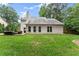 Exterior of home with stone patio and lush green lawn at 1340 Gran Forest Dr, Cumming, GA 30041