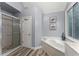 Modern bathroom featuring a glass-enclosed shower, soaking tub, and neutral paint at 1340 Gran Forest Dr, Cumming, GA 30041