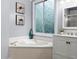 Stylish bathroom offers a soaking tub, frosted privacy window, and modern fixtures at 1340 Gran Forest Dr, Cumming, GA 30041