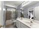 Bathroom with double sink, vanity, and tiled walk-in shower at 1340 Gran Forest Dr, Cumming, GA 30041