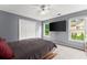Grey bedroom with a tv and a large window allowing lots of natural light at 1340 Gran Forest Dr, Cumming, GA 30041