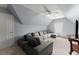 Bonus room with large sectional couch, tv, and dormer windows at 1340 Gran Forest Dr, Cumming, GA 30041