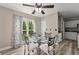 Bright breakfast nook features a glass table set, wood floors, and natural light from a nearby window at 1340 Gran Forest Dr, Cumming, GA 30041