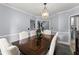Bright dining room boasts stylish furnishings, complemented by modern light fixtures, and an open staircase view at 1340 Gran Forest Dr, Cumming, GA 30041