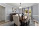 Elegant dining room with a modern chandelier, dining table set, and a decorative area rug at 1340 Gran Forest Dr, Cumming, GA 30041