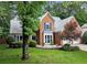 Charming two-story brick home with well-manicured lawn and landscaping at 1340 Gran Forest Dr, Cumming, GA 30041