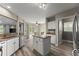 Bright kitchen boasts granite countertops, stainless steel appliances, white cabinetry, and a functional island at 1340 Gran Forest Dr, Cumming, GA 30041