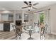 Cozy breakfast nook next to the kitchen with glass table, decorative chairs, and a view to the living room at 1340 Gran Forest Dr, Cumming, GA 30041